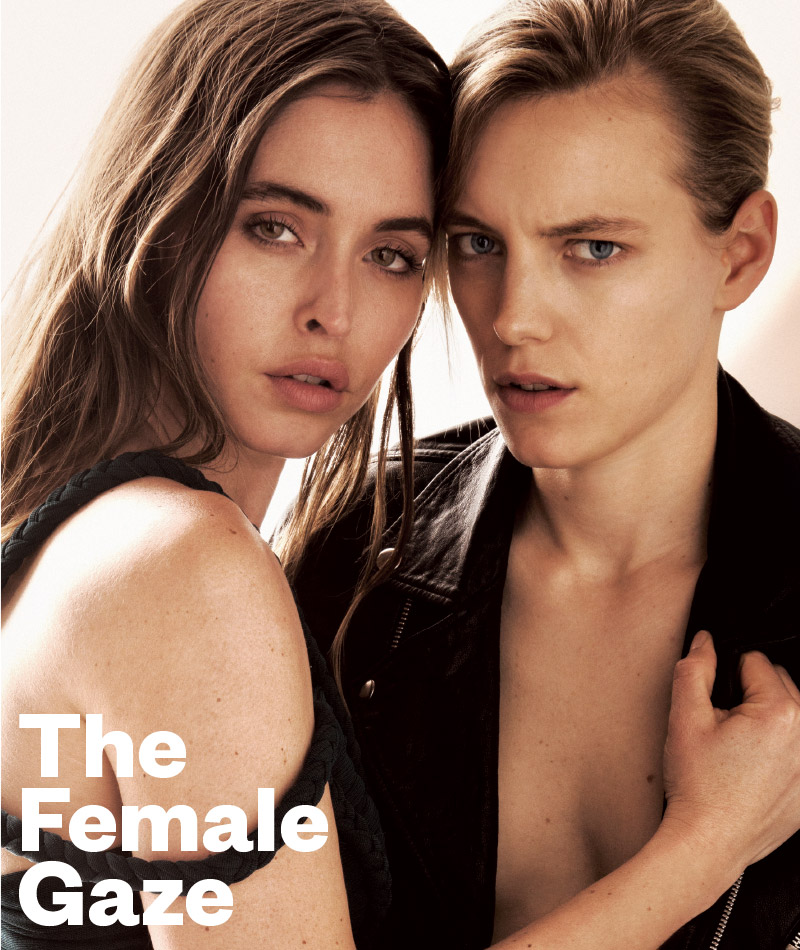 Two women holding each other on the cover of GCN Issue 332 with the words the female gaze written in front of them