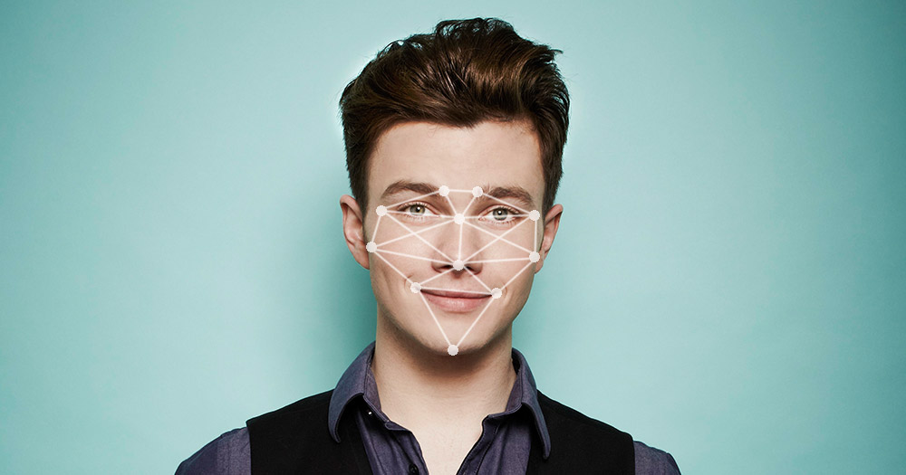 A picture of a gay person with dots and lines over their face which symbolise the artificial intelligence program that recognises facial structures that can determine if you are gay or straight