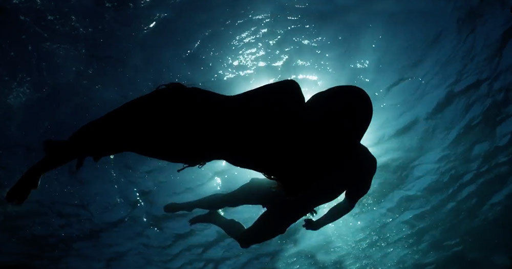 A scene from the new fifty shades trailer showing two silhouettes underneath water