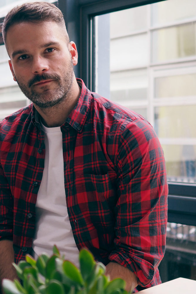 Kris Nelson sitting in a red flannel shirt and who is pro march for choice