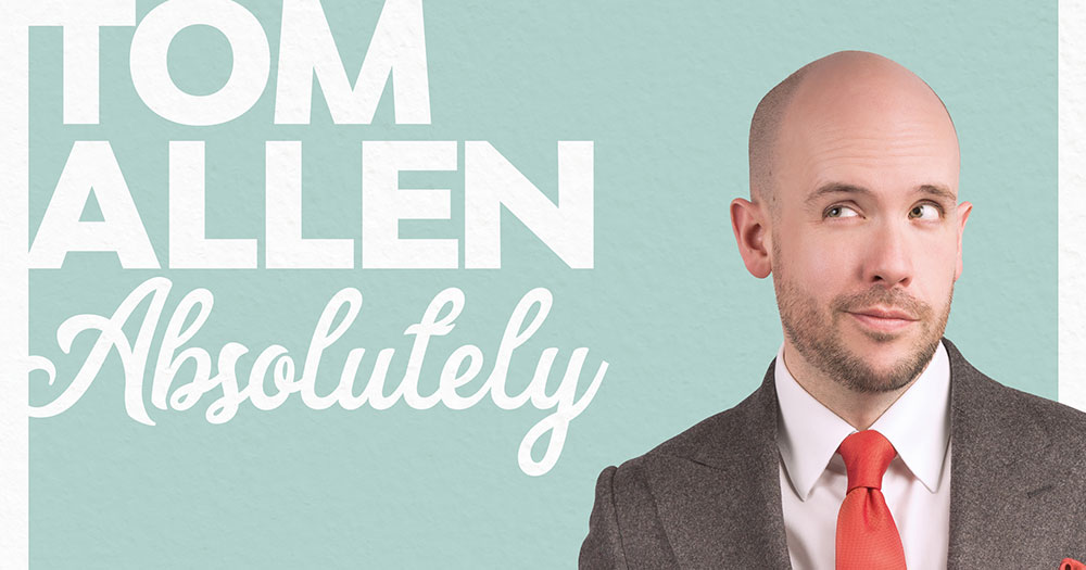 Tom Allen absolutely in a suit with a red tie