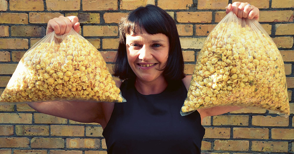 Ruth Ormiston from Cornude holding two bags of popcorn
