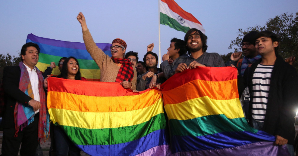 Indian LGBT people holding a pride flag protesting Section 377