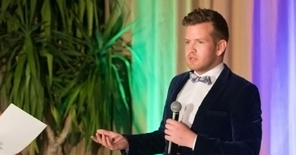 mr gay limerick 2017 speaks into a microphone at an event