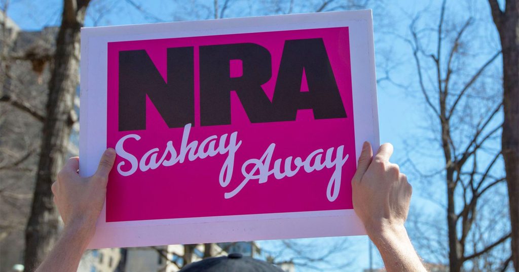 March For Our Lives protester holding a sign that says 'NRA Sashay Away"