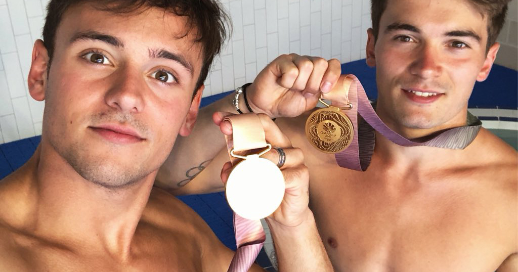 Tom Daley and Daniel Goodfellow holding their gold medals