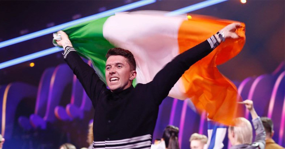 Ryan O'Shaughnessy holds the Irish flag aloft at the eurovision final