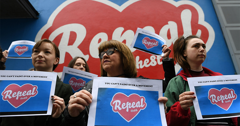 Women holding repeal signs