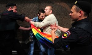 Russian police officers detain gay rights protesters in Moscow