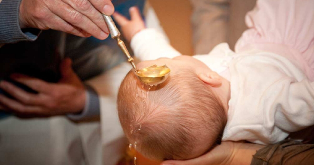 A child undergoing the anointing during their baptism