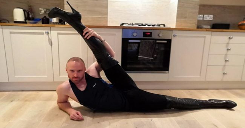 Dancer Pavel Vacek wearing heels poses on his kitchen floor with one leg kicked over his head