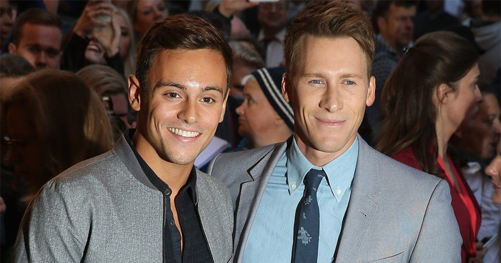 Tom Daley and Dustin Lance Black pose for press shots at a public event
