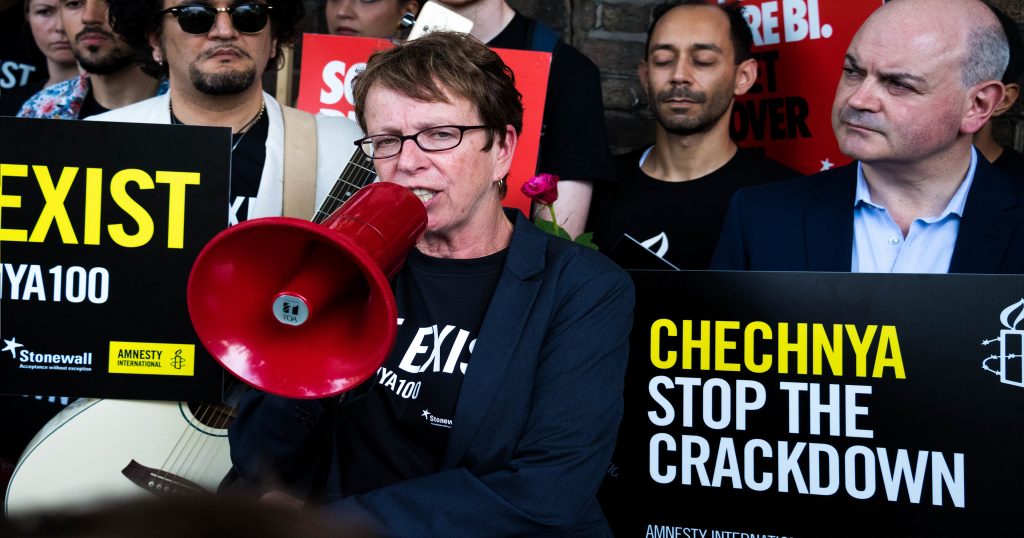 Protestors holding signs protesting Chechnya's treatment of LGBT+ people.