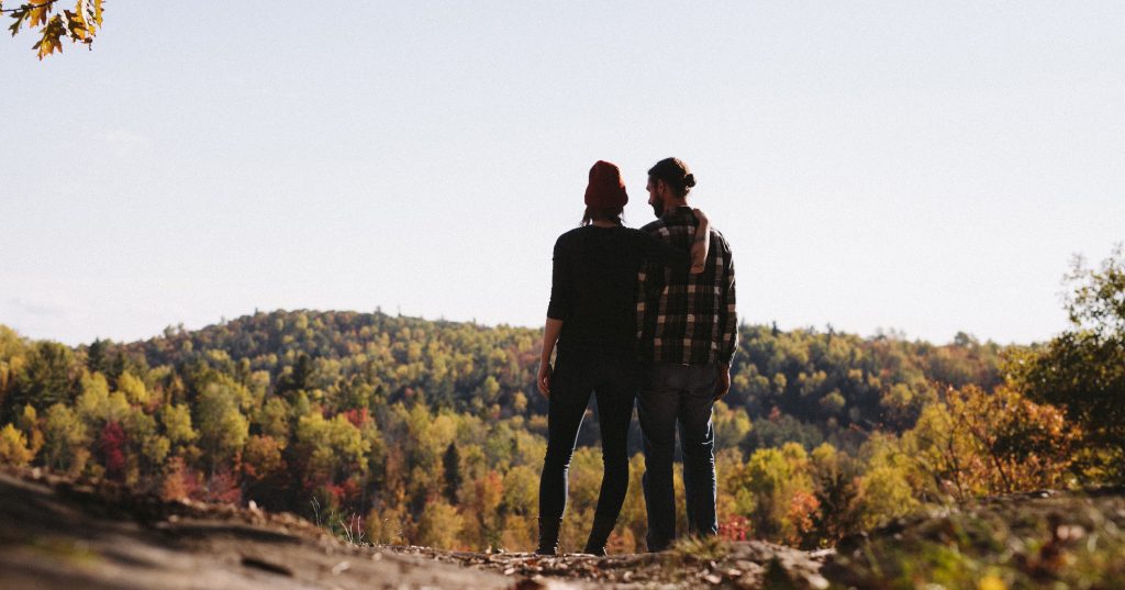Image of two men together looking over a hill.