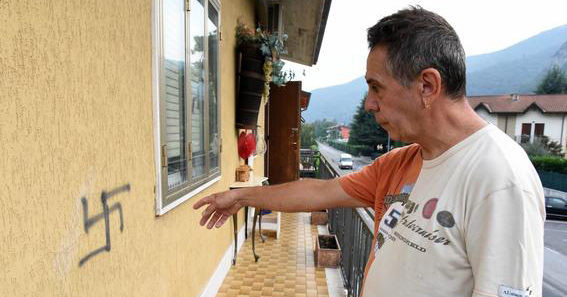 One of the victims showing a swastika graffiti outside his house in Verona