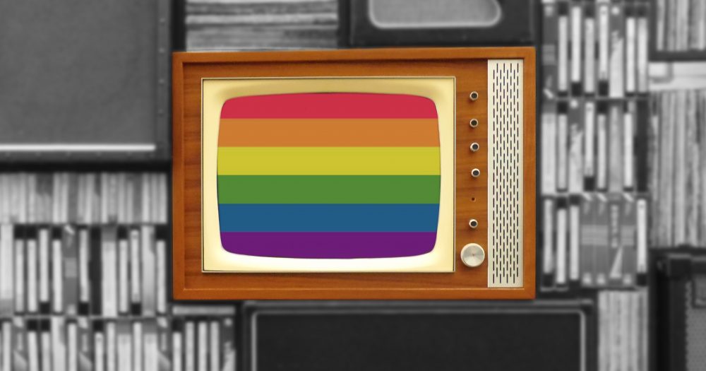 An old TV shows with a rainbow flag on the screen against a black and white background
