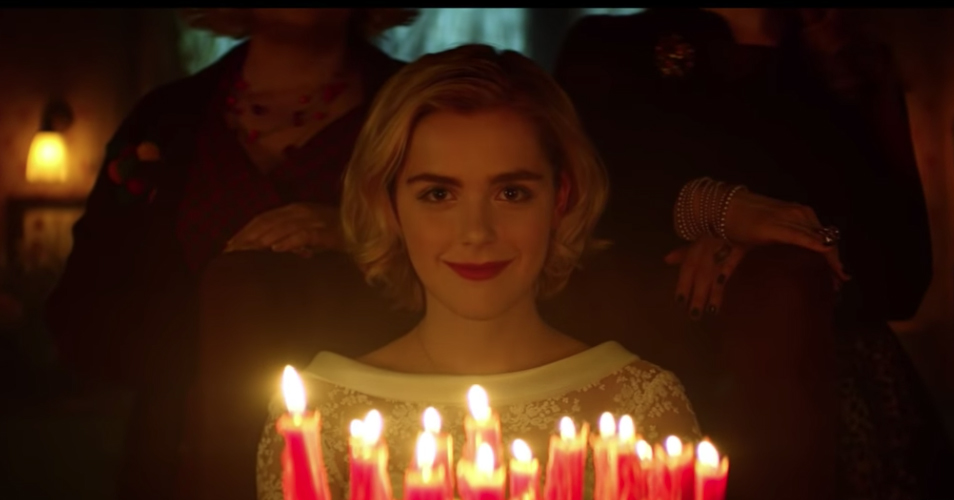 Image of Kiernan Shipka blowing out candles in Sabrina remake.