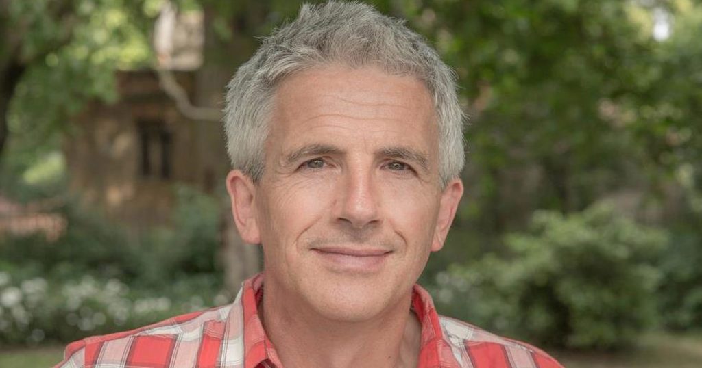 Headshot of author Patrick Gale with trees in the background