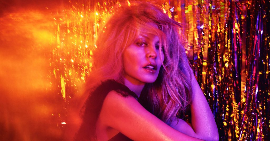 Kylie Minogue looking into the camera with her hair blowing over her face