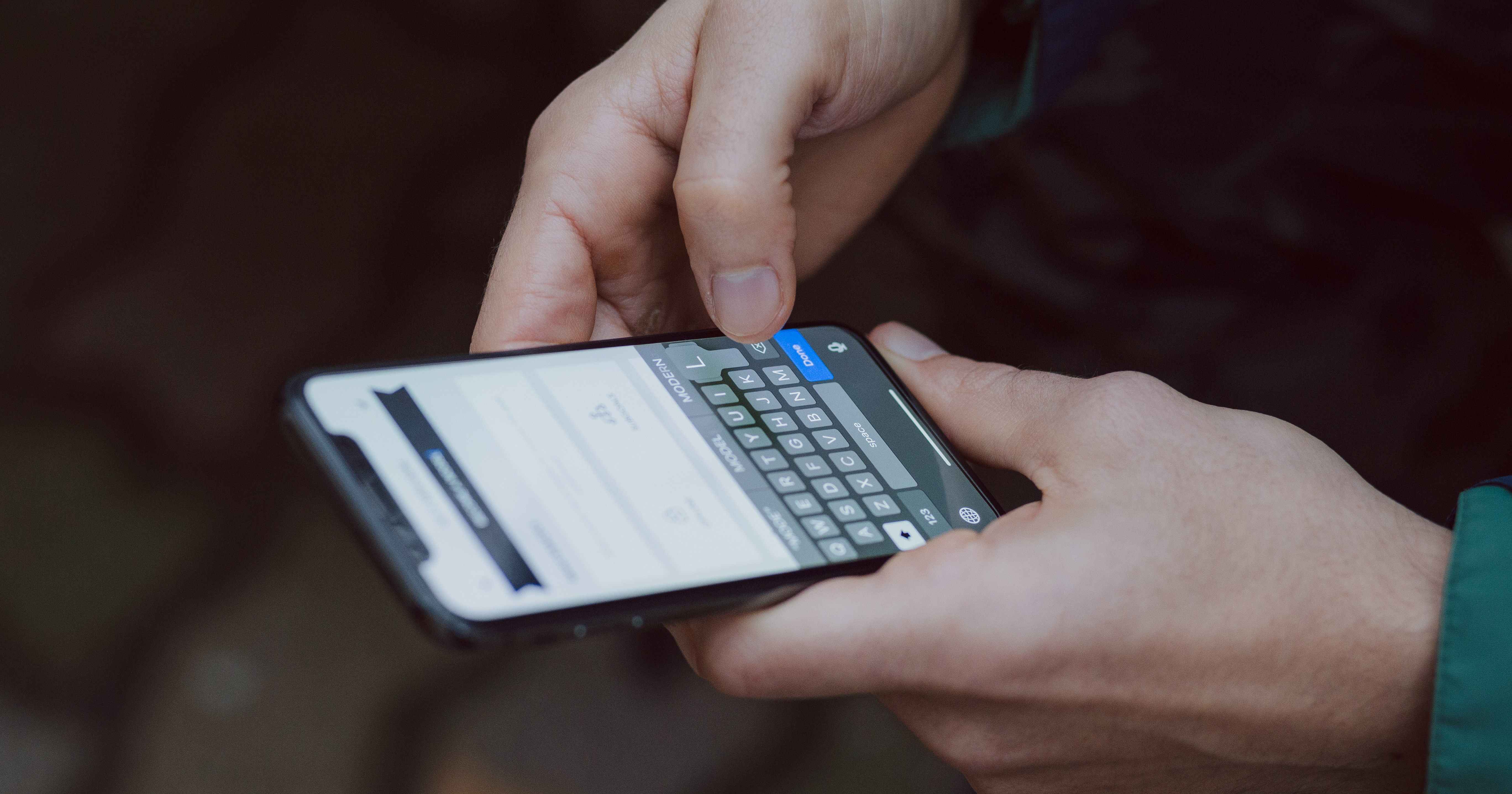 Close up image of male holding an iPhone