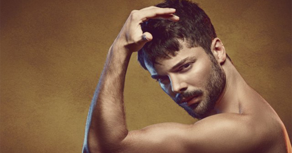 Turkish pop star Bulut Duman posing topless flexing his arm toward his head