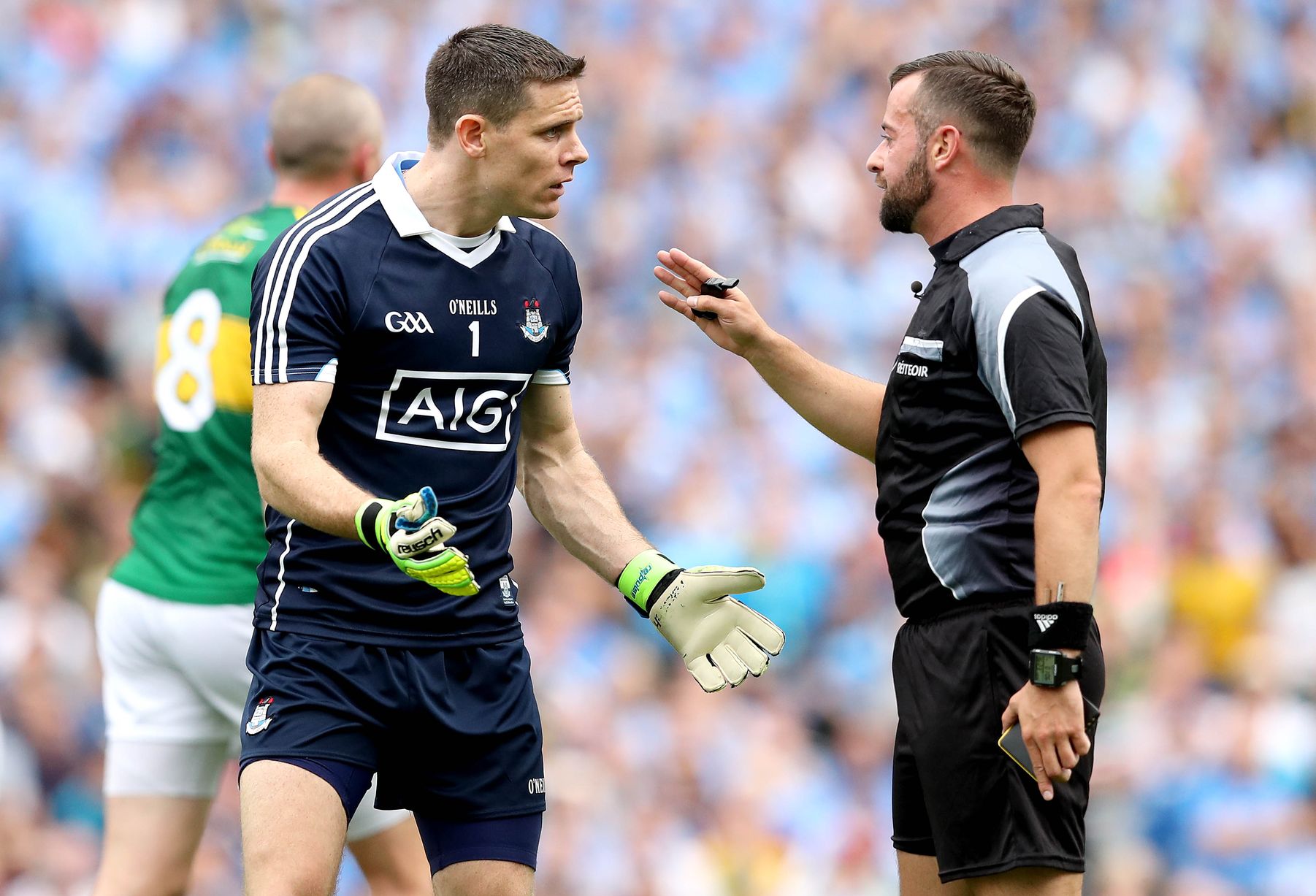 David Gough talking to a GAA player on the pitch during a match, arguing with him