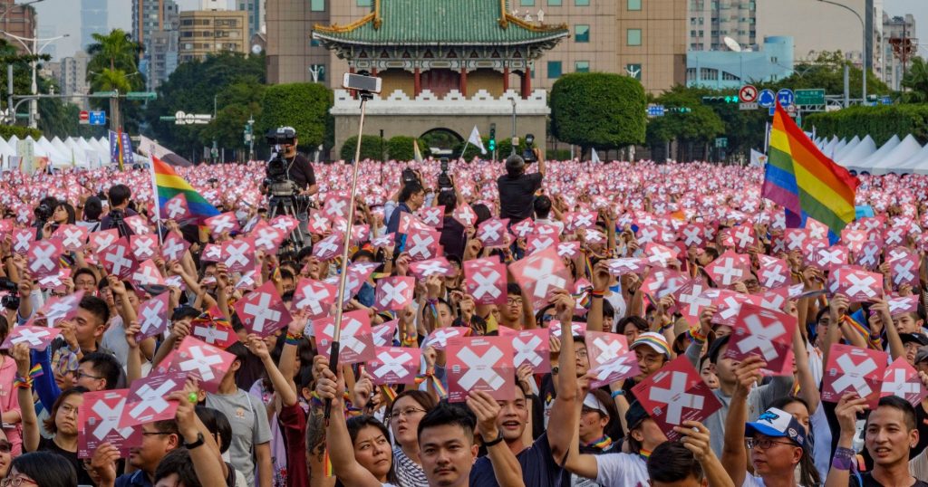 LGBT community march in Taiwan ahead of marriage equality referendum, holding up posters with X on them