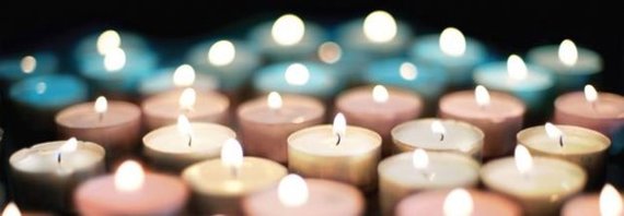 Candles being lit up in the trans colours for trans day of remembrance, to memorialize those who have died because of transphobic violence