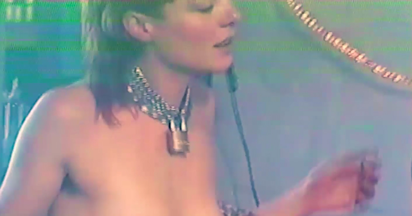 A still from Evvol's video 'Release Me', featuring a woman wearing a chain collar.