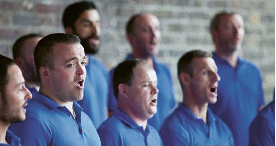A group of men singing in a choir.