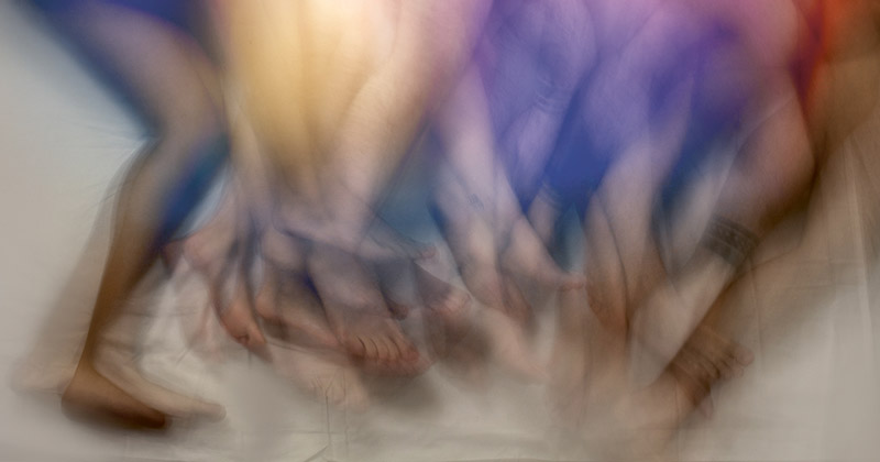 A picture of different people's legs tangled at an after party