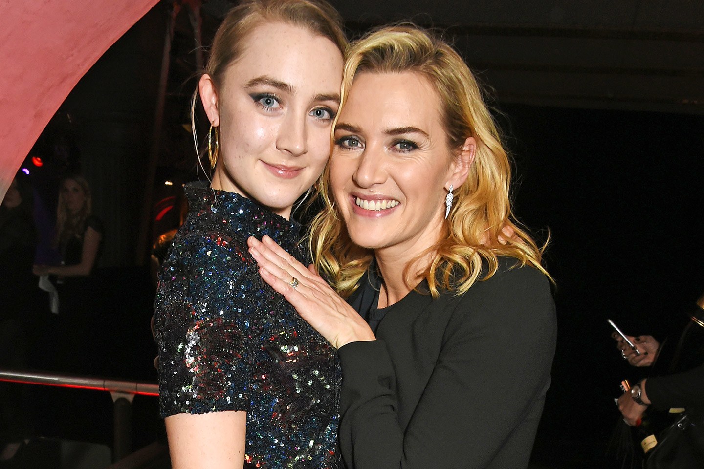 Saoirse Ronan and Kate Winslet hugging.
