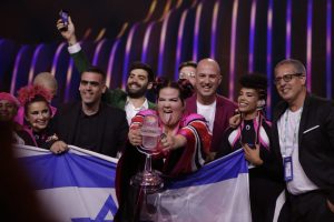 The Israel Eurovision team hold up their flag and trophy