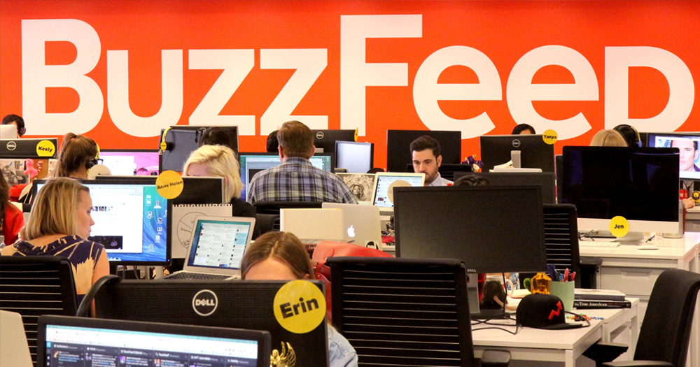 BuzzFeed offices where people are working in front of a big BuzzFeed sign.
