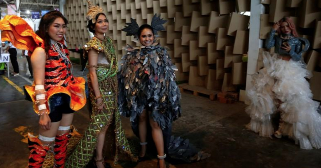 Four models pose wearing plastic couture produced by the designers of the collective.