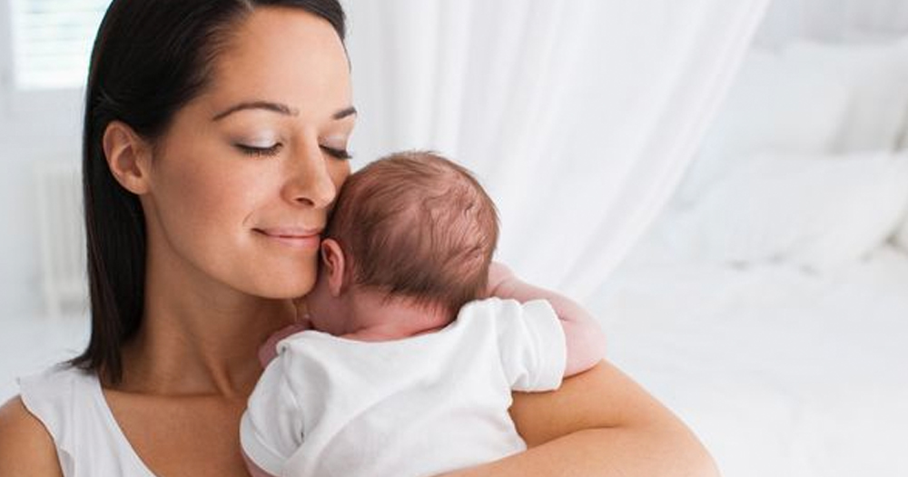 Image of a woman holding her baby.