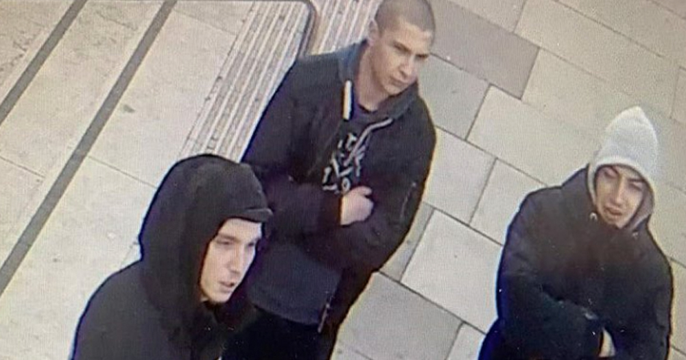Image of three men, two with their hoods up on the street, taken from CCTV.