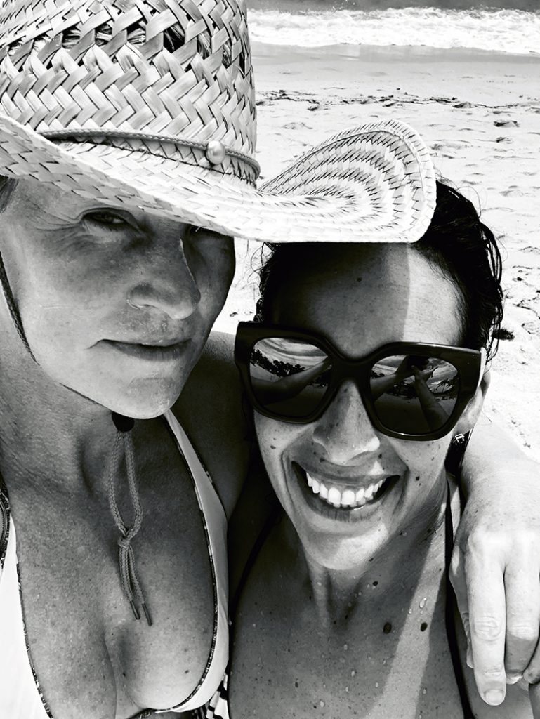 Fi Connors (right) wearing a hat and her partner Tina (left) wearing sunglasses