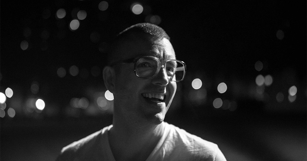 Paul Rowley in a black and white photo smiling