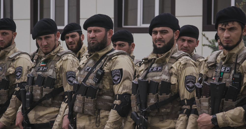 Image of armed Chechen soldiers standing beside each other in uniform.