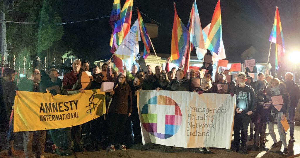 LGBT community supporting Chechnya hold banners and rainbow flags outside the Russian Embassy