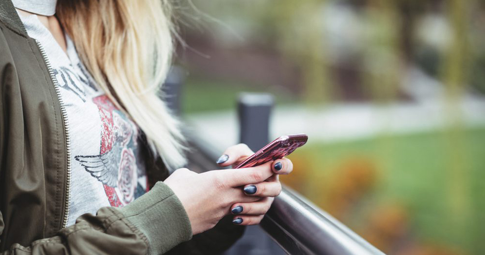 Woman on phone using LGBT+ apps