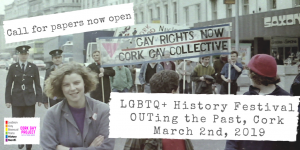 Two women leading a gay rights march with the Gay Project logo over the picture