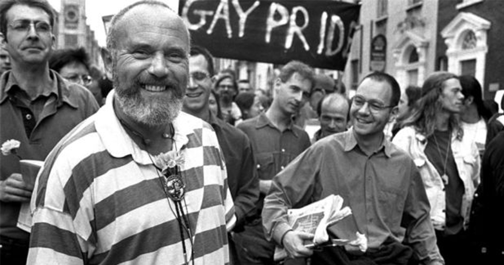 David Norris, who will launch Gay Project Cork's OUTing festival, smiling at the front of a group of gay activists holding banners