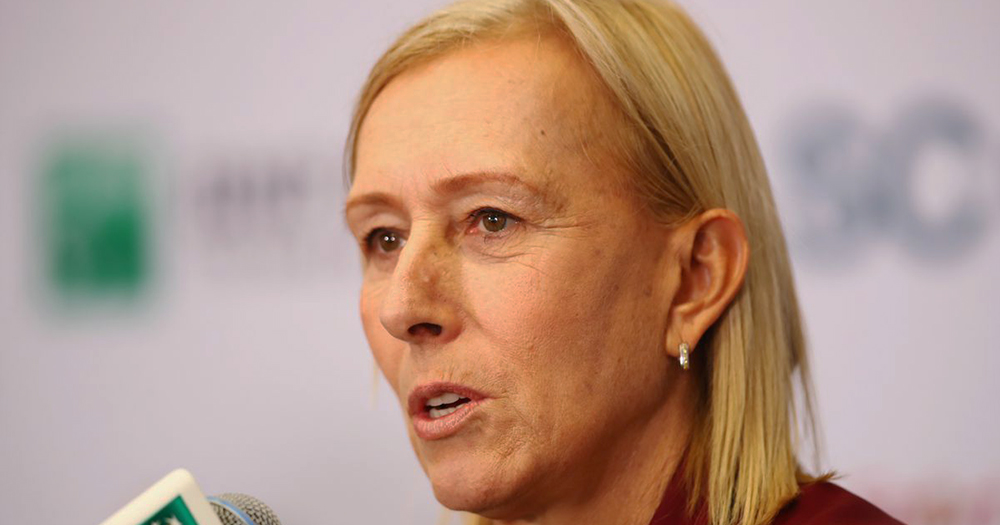 A close up of Martina Navratilova speaking into a microphone at a press conference