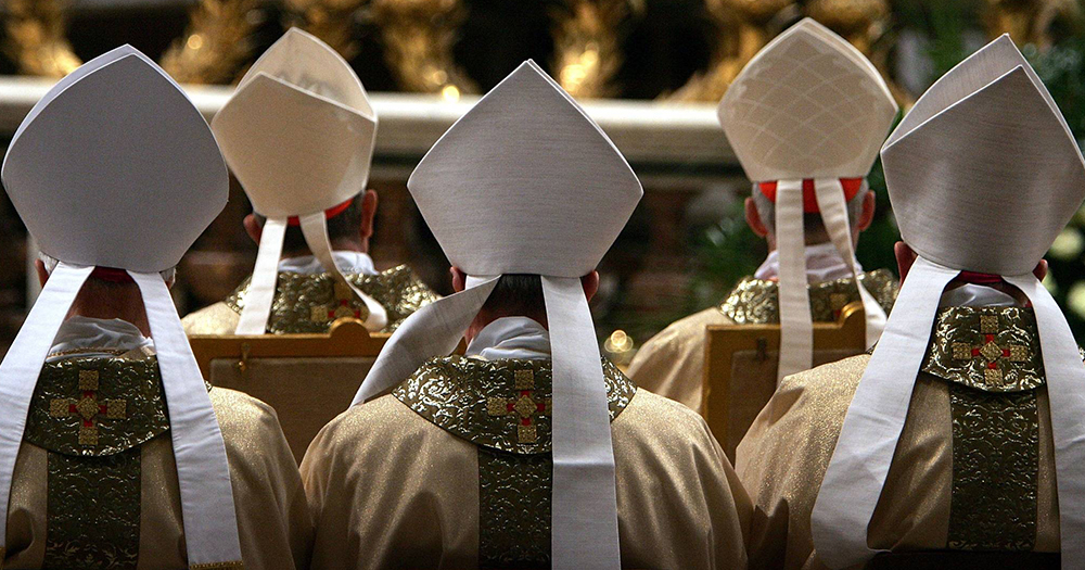 A group of priests at mass seen from behind