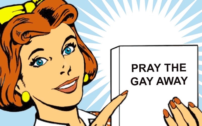 Woman with short orange hair pointing to a book titled 'Pray the Gay Away'