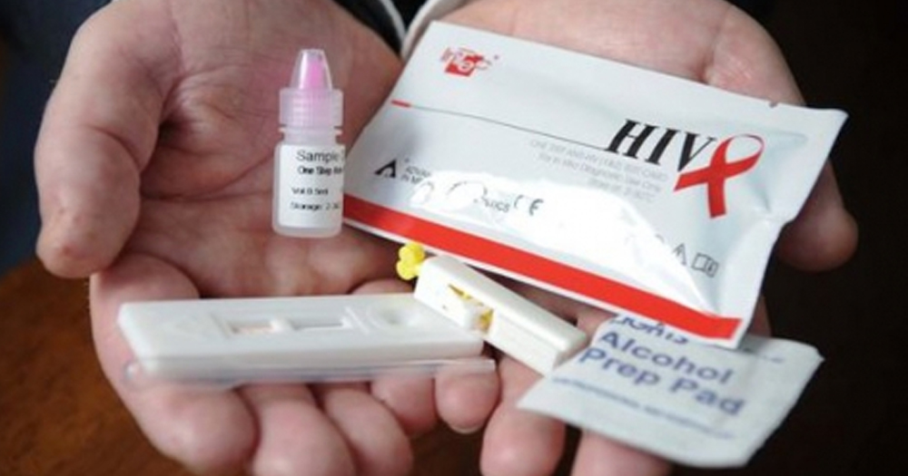 A HIV test kit in the hands of a patient.