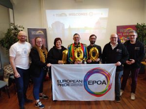 Dublin Pride organisers holding a banner while being inducted into the European Pride Organisers Association.