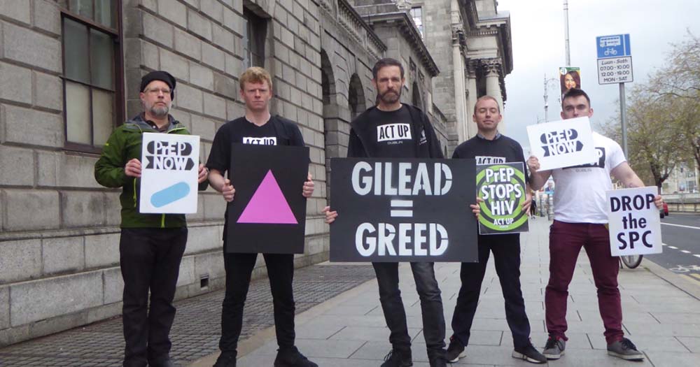Activists outside the Four courts holding protest signs against pharmaceutical giant Gilead